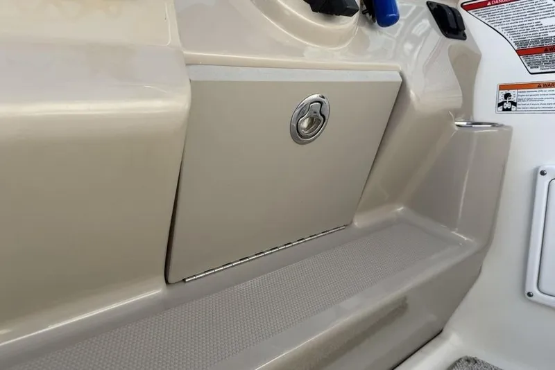 Slide: The Image of 2007 Sea Ray Sundancer 540 boat interior with storage compartment and safety labels. - 9