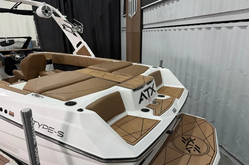 Slide: The Image of 2022 ATX Surf Boats 24 Type-S with tan seating and sleek design in showroom. - 10