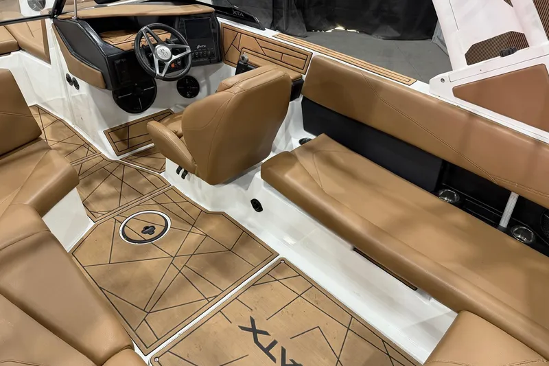 Slide: The Image of 2022 ATX Surf Boats 24 Type-S interior with tan seating and modern dashboard design. - 6