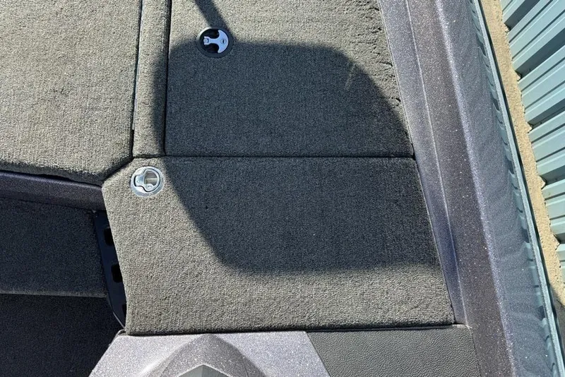 Slide: The Image of Carpeted deck of 2021 Skeeter ZXR21 boat with metal latch and shadow. - 11