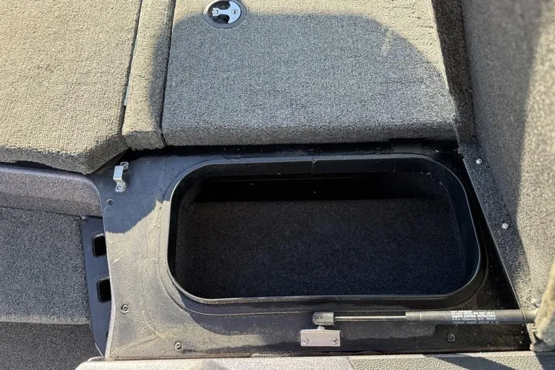 Slide: The Image of 2021 Skeeter ZXR21 boat storage compartment with carpeted interior. - 13