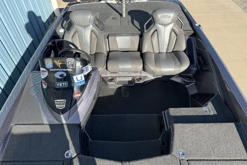 Slide: The Image of 2021 Skeeter ZXR21 boat interior with dual seats and sticker-adorned console. - 16