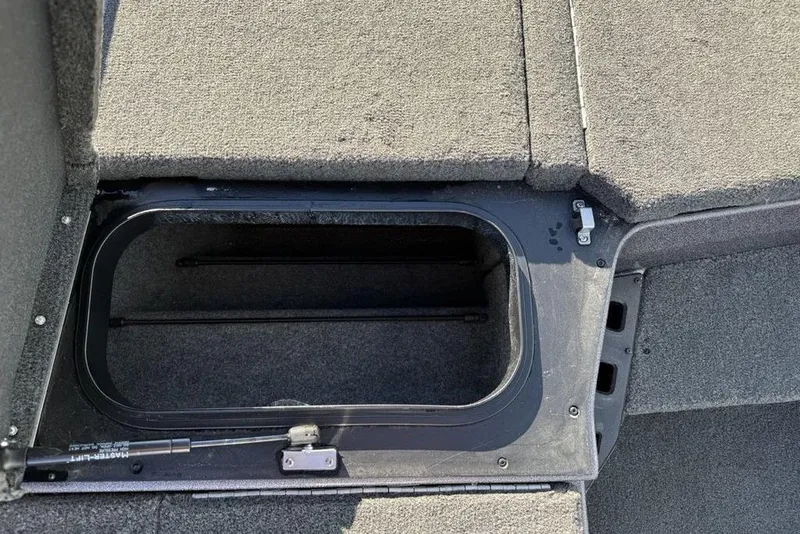 Slide: The Image of 2021 Skeeter ZXR21 boat storage compartment with open lid, showcasing interior space. - 18