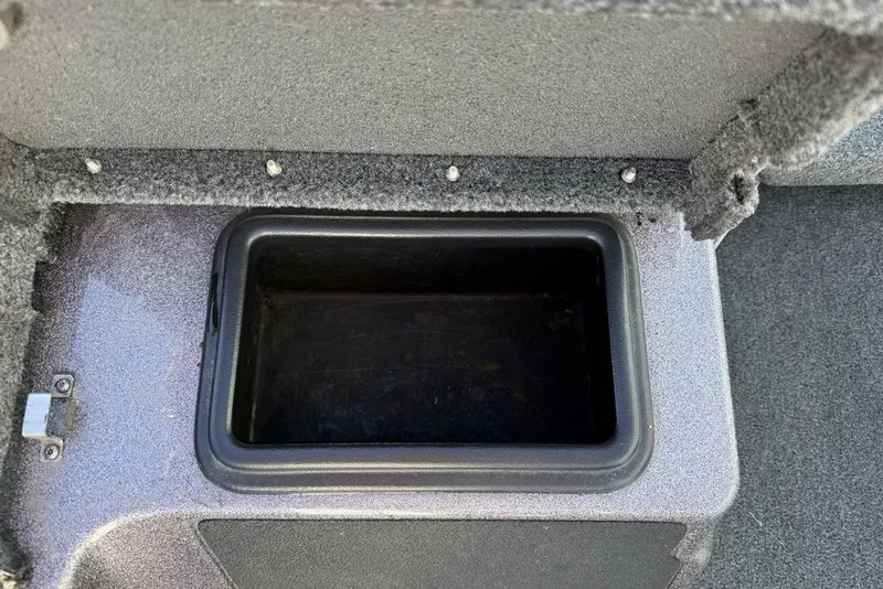 Slide: The Image of Storage compartment in 2021 Skeeter ZXR21 boat, featuring a durable, carpeted interior. - 19
