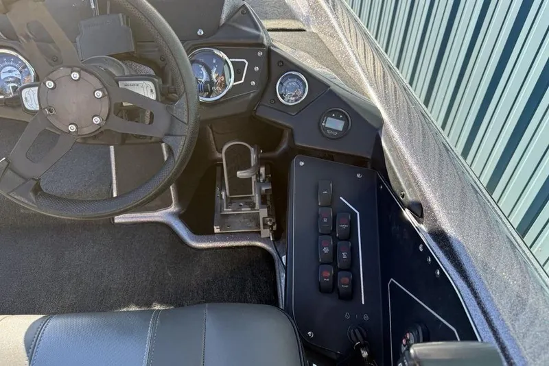 Slide: The Image of Interior of 2021 Skeeter ZXR21 boat showing steering wheel and control panel. - 20