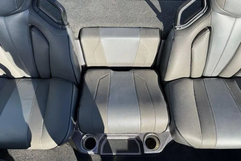 Slide: The Image of 2021 Skeeter ZXR21 boat seats with cup holders, featuring gray upholstery. - 22