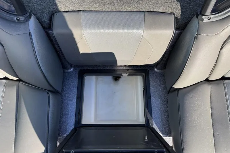 Slide: The Image of Interior of 2021 Skeeter ZXR21 boat showing storage compartment between seats. - 25