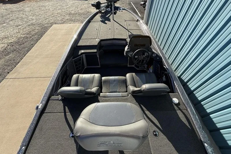 Slide: The Image of 2021 Skeeter ZXR21 boat interior with gray seating and steering console. - 28