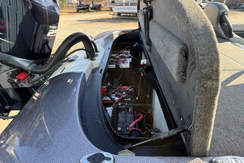 Slide: The Image of Open battery compartment of 2021 Skeeter ZXR21 boat with visible wiring and engine. - 29
