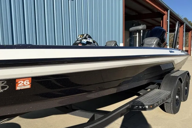Slide: The Image of 2021 Skeeter ZXR21 boat parked near blue metal building. - 3