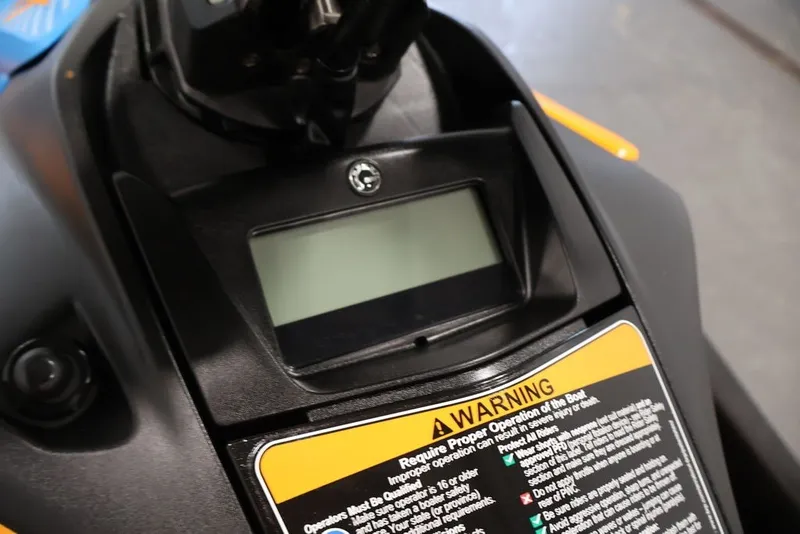 Slide: The Image of Dashboard of 2026 Sea-Doo Spark Trixx with warning label and display screen. - 12