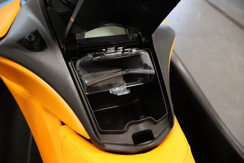 Slide: The Image of 2026 Sea-Doo Spark Trixx storage compartment, open view, showcasing interior design. - 13