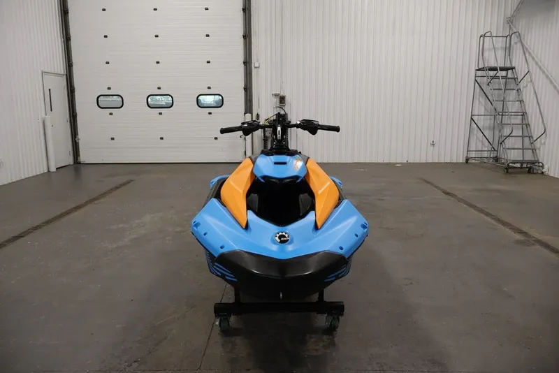 Slide: The Image of 2026 Sea-Doo Spark Trixx for 1 in a garage, blue and orange design. - 8