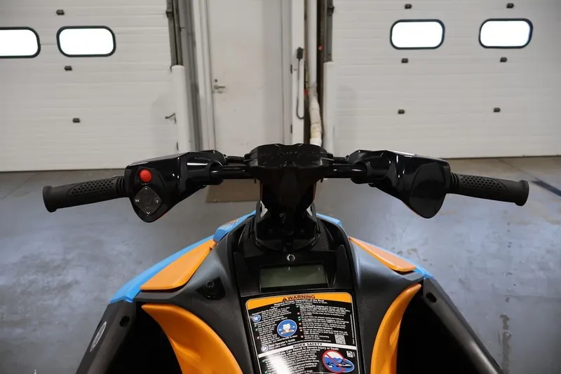 Slide: The Image of Handlebars of 2026 Sea-Doo Spark Trixx for 1 in a garage setting. - 10
