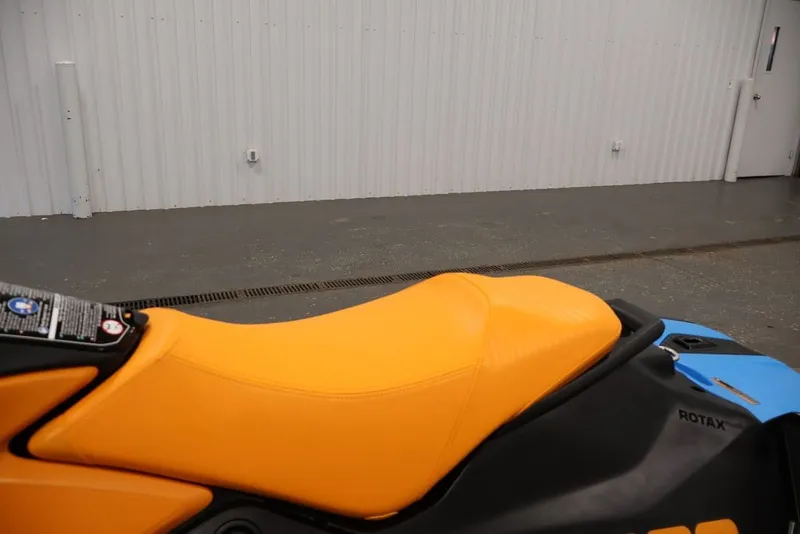Slide: The Image of 2026 Sea-Doo Spark Trixx jet ski with vibrant orange seat, side view. - 17