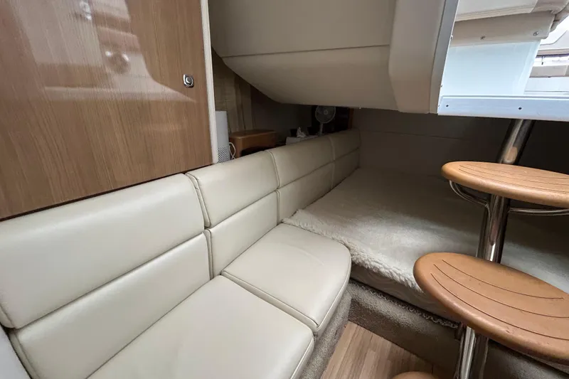 Slide: The Image of Interior of 2017 Formula 350 Crossover Bowrider, featuring cozy seating and wooden accents. - 17