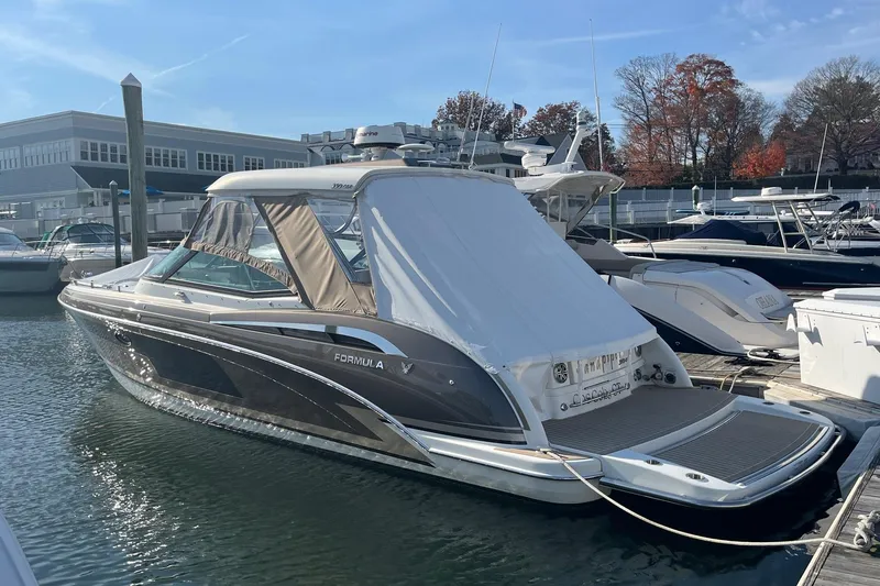 Slide: The Image of 2017 Formula 350 Crossover Bowrider docked at marina, covered and ready for use. - 2