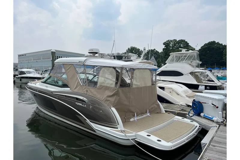 Slide: The Image of 2017 Formula 350 Crossover Bowrider docked at marina, featuring sleek design and covered seating. - 3