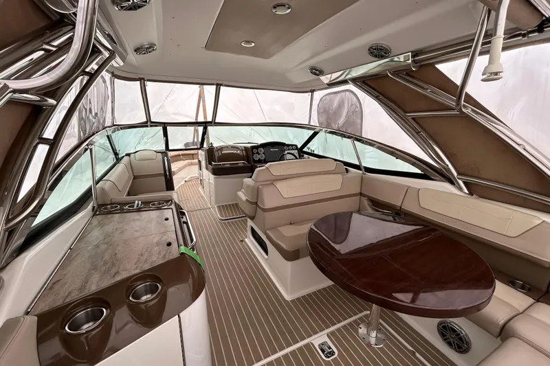 Slide: The Image of 2017 Formula 350 Crossover Bowrider interior with seating, table, and helm. - 5