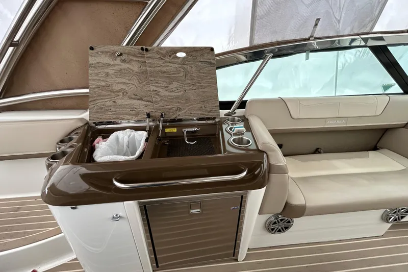 Slide: The Image of 2017 Formula 350 Crossover Bowrider interior with kitchenette and seating area. - 7