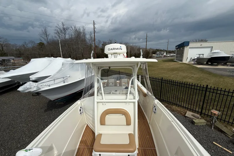 Slide: The Image of 2015 Sailfish 2860 CC boat with Garmin equipment, docked outdoors under cloudy skies. - 2