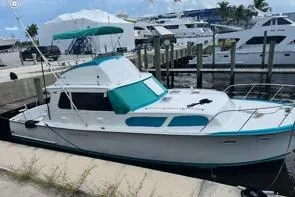 The Image of 1961 Hatteras 41 Convertible boat docked at marina, featuring classic design and teal accents. - 1