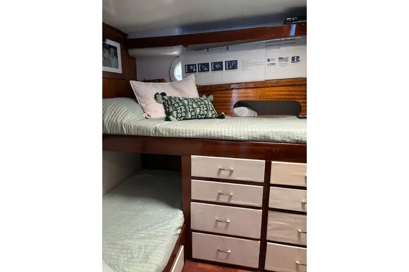 Slide: The Image of Cozy cabin interior of 1961 Hatteras 41 Convertible with bunk beds and storage drawers. - 5