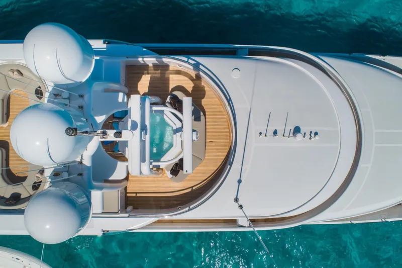 Slide: The Image of Aerial view of 1988 Van Mill Custom yacht with deck and jacuzzi, in clear blue water. - 103