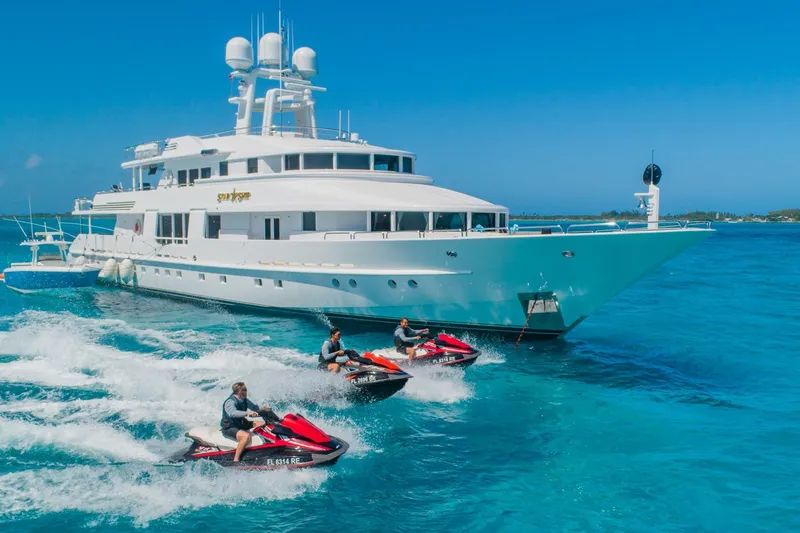 Slide: The Image of Luxurious 1988 Van Mill Custom yacht with jet skis in clear blue ocean. - 105