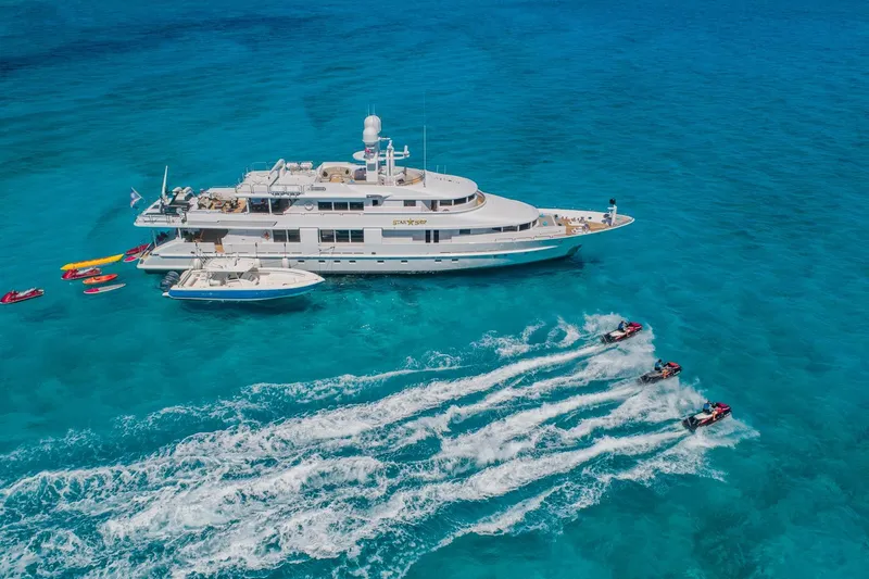 Slide: The Image of Luxury yacht "Van Mill Custom 1988" with jet skis in turquoise ocean. - 107