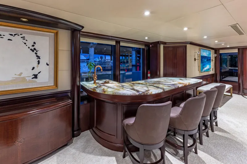Slide: The Image of Luxurious yacht interior with elegant bar, marble countertop, and plush seating, Van Mill Custom 1988. - 31