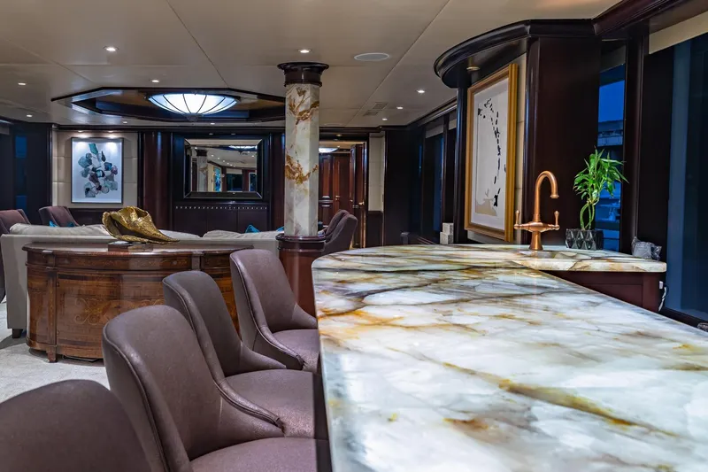 Slide: The Image of Luxurious yacht interior with marble countertops, elegant seating, and modern decor, Van Mill Custom 1988. - 32