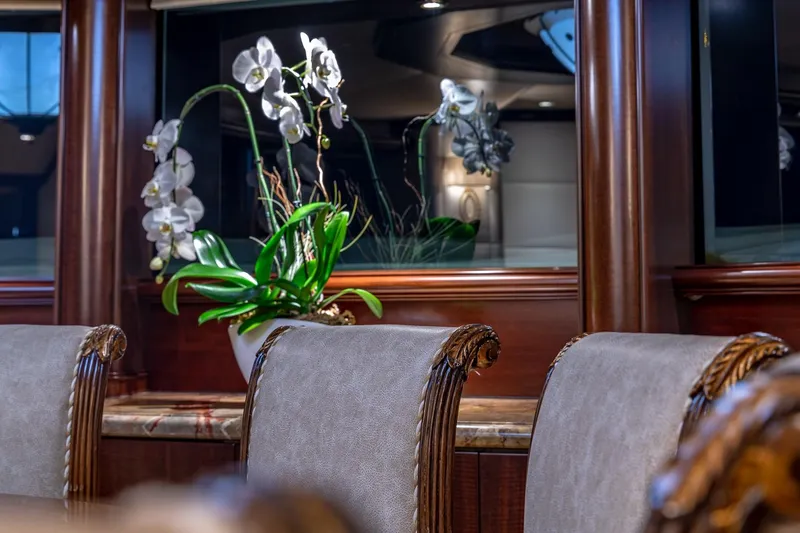Slide: The Image of Luxurious Van Mill 1988 yacht interior with elegant chairs and decorative orchids. - 40