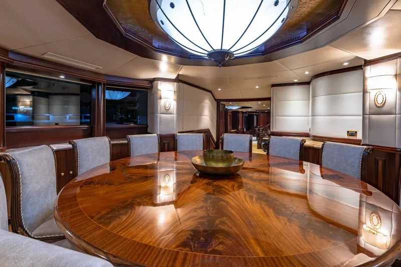 Slide: The Image of Luxurious dining area in 1988 Van Mill Custom yacht with elegant wood table and plush seating. - 47