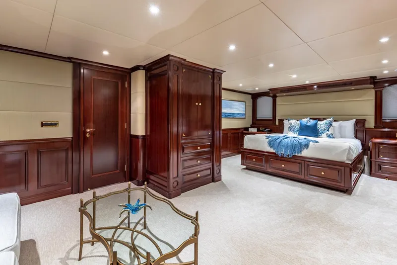 Slide: The Image of Luxurious yacht bedroom with elegant wood paneling, plush bedding, and stylish decor, Van Mill 1988. - 54