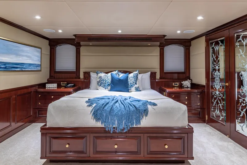 Slide: The Image of Luxurious 1988 Van Mill Custom yacht bedroom with elegant wood finishes and blue accents. - 55