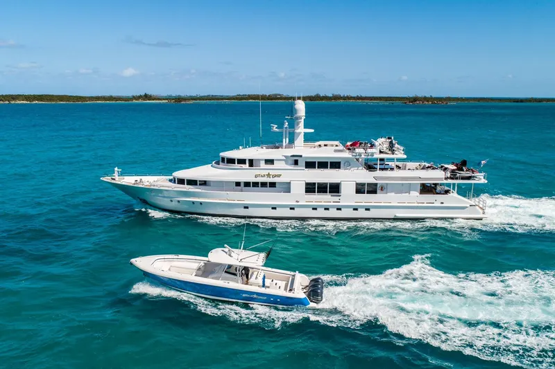 Slide: The Image of Luxury yacht and speedboat cruising in clear blue ocean waters. - 6