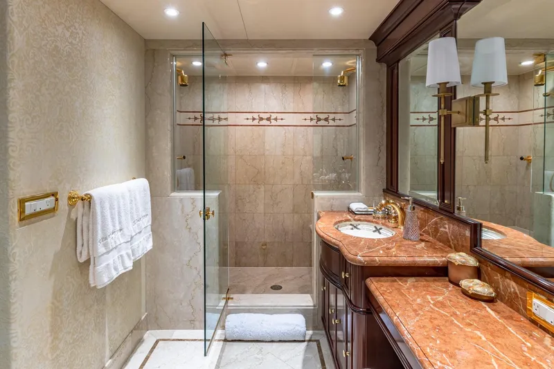 Slide: The Image of Luxurious bathroom with marble countertops, glass shower, and elegant lighting in a 1988 Van Mill Custom. - 61