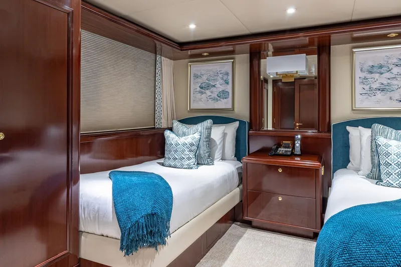 Slide: The Image of Luxurious 1988 Van Mill Custom yacht cabin with twin beds, elegant wood finish, and blue accents. - 62