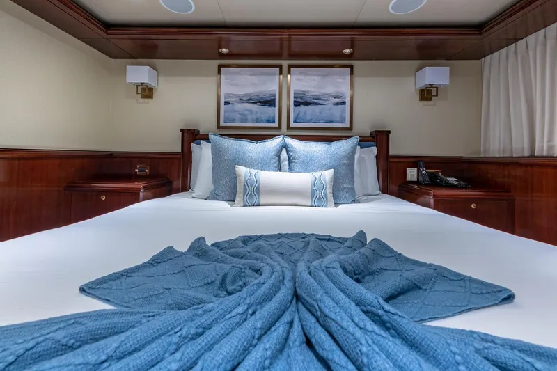 Slide: The Image of Luxurious 1988 Van Mill Custom yacht bedroom with elegant blue bedding and wooden accents. - 75