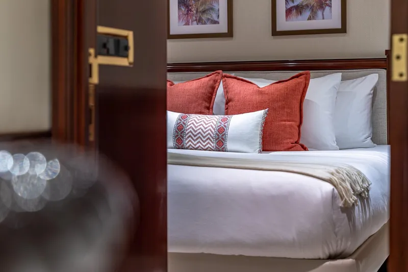 Slide: The Image of Luxurious bedroom interior with red cushions on a bed, aboard a 1988 Van Mill Custom yacht. - 77