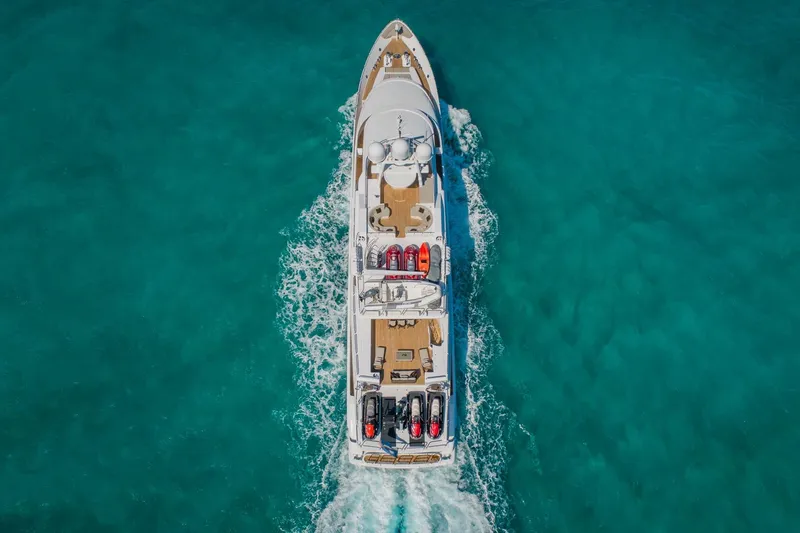 Slide: The Image of Aerial view of 1988 Van Mill Custom yacht cruising in clear turquoise waters. - 9