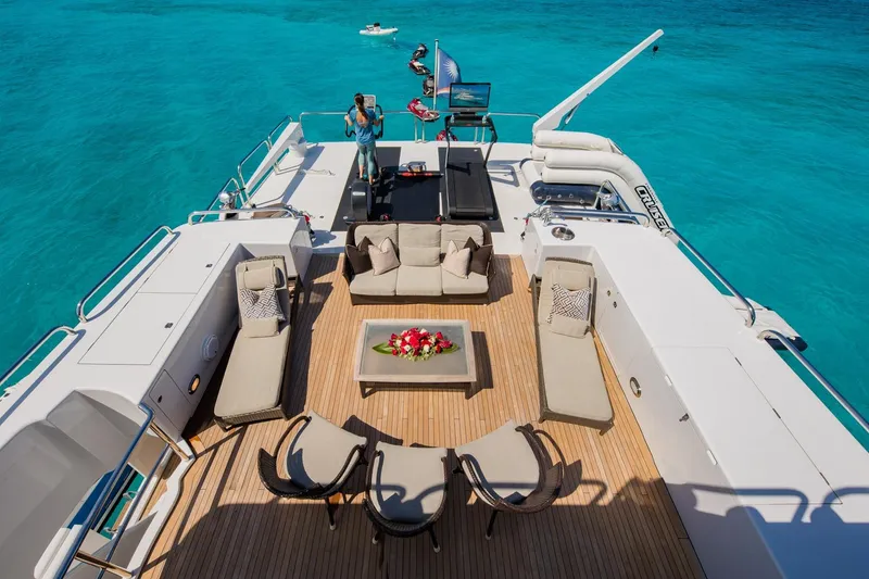 Slide: The Image of Luxurious 1988 Van Mill Custom yacht deck with elegant seating, surrounded by turquoise waters. - 91