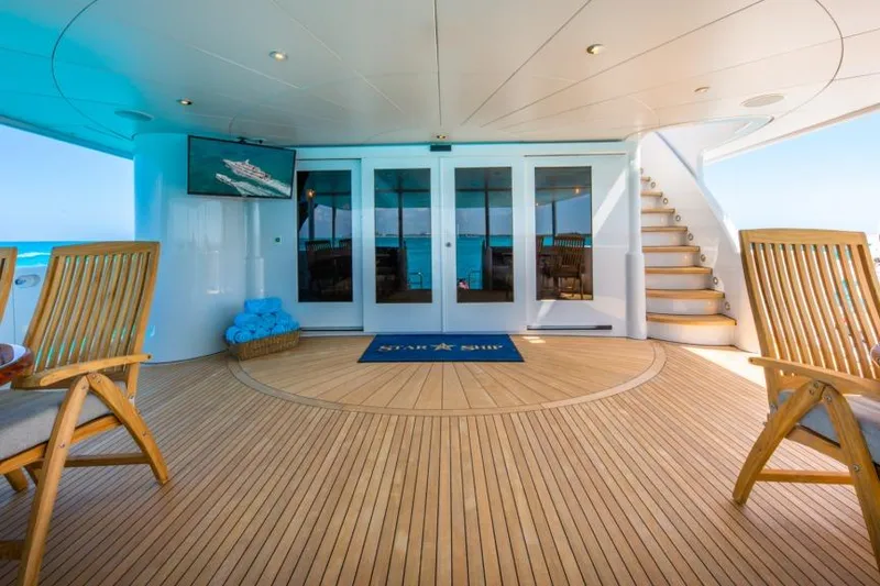 Slide: The Image of Luxurious yacht deck with wooden flooring, chairs, and ocean view, Van Mill Custom 1988. - 96