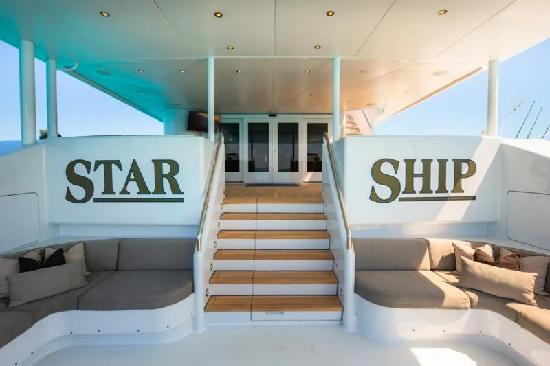 Slide: The Image of Luxurious 1988 Van Mill Custom yacht deck with "Star Ship" signage and elegant seating. - 99