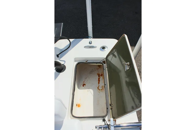 Slide: The Image of Open storage compartment on 2017 Sterling TR7 boat, showing interior details. - 13