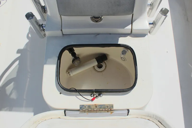 Slide: The Image of Open compartment on a 2017 Sterling TR7 boat with a pump inside. - 24