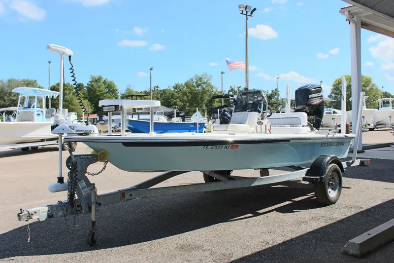 Slide: The Image of 2017 Sterling TR7 boat on trailer in sunny marina setting. - 5