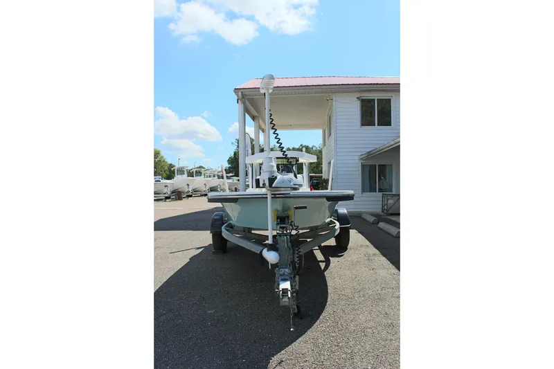 Slide: The Image of 2017 Sterling TR7 boat on trailer, parked near a white building under a clear sky. - 6