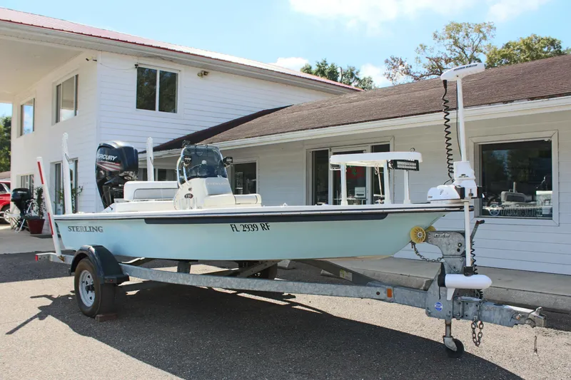 Slide: The Image of 2017 Sterling TR7 boat on trailer outside a building, featuring Mercury engine. - 7